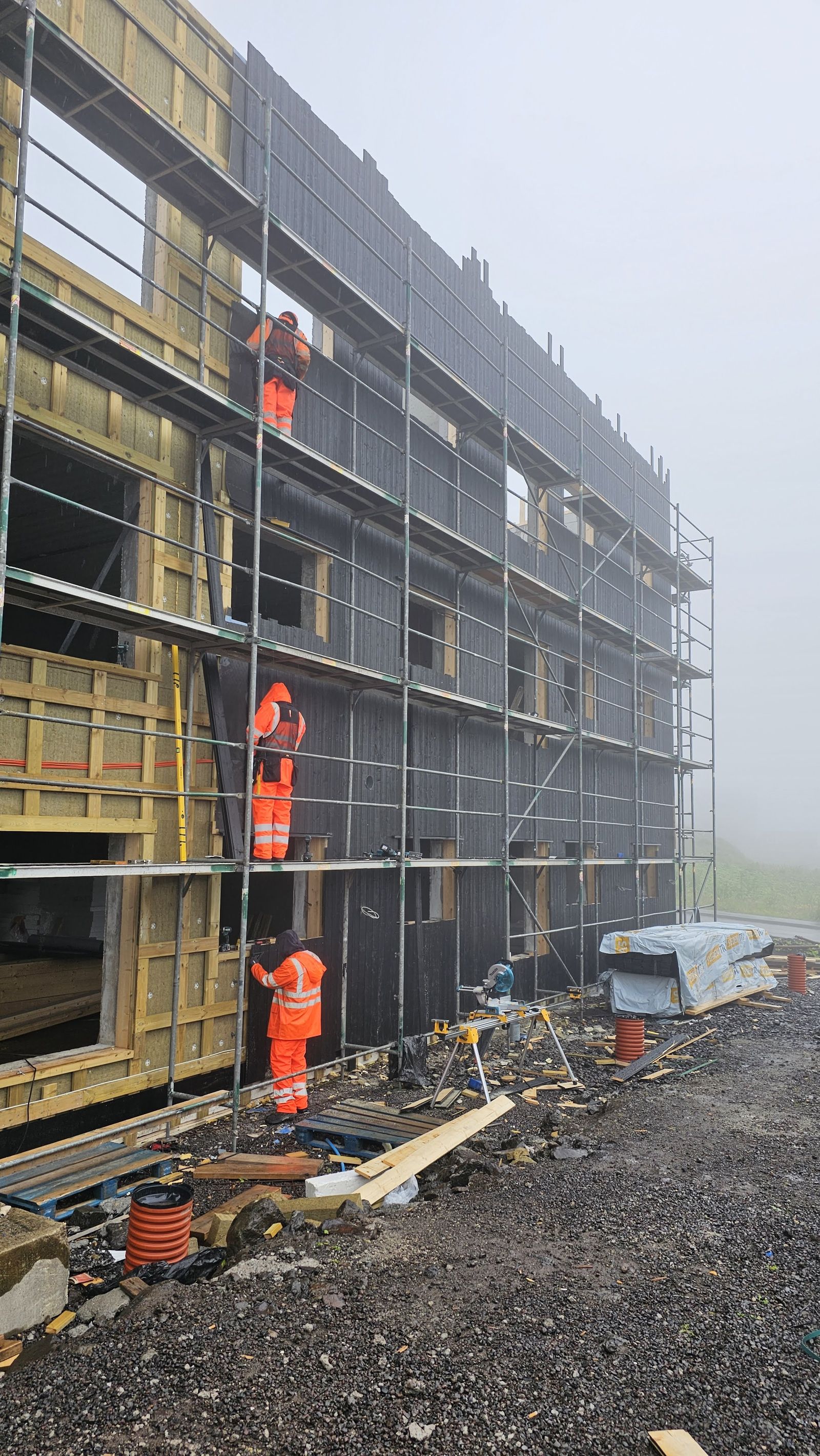 Construction workers on scaffolding at a Faroese building site